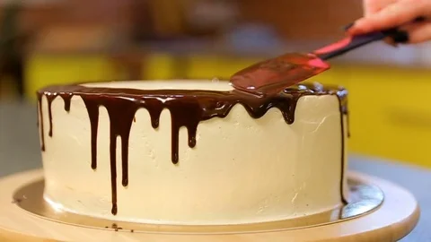 Confectioner making chocolate cake. The process of making a cake. Pastry covered Stock Footage 82088679