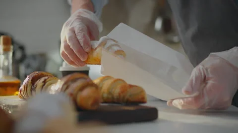 Confectioner. The master pastry chef, wearing protective gloves, prepares or Stock Footage 271149109