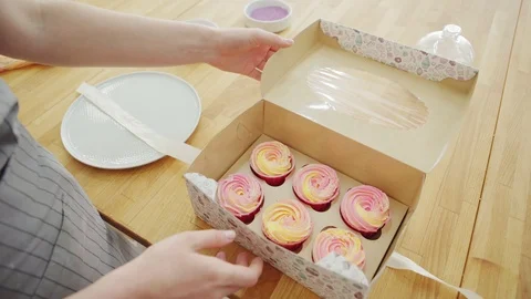 Confectioner packaging fresh cupcakes Stock Footage 108879730