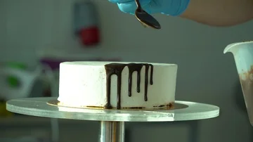 Confectioner pours chocolate on cake Stock Footage 85662447