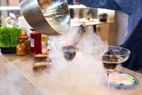 Confectioner Pours Chocolate Eclair With Liquid Nitrogen Stock Photos