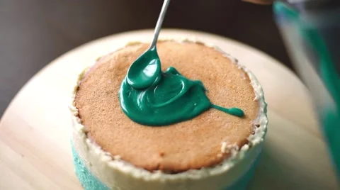 Confectioner pours icing on the sponge cake Stock Footage 67515441