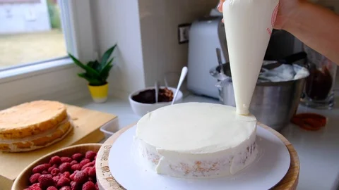 A confectioner prepares a cream cake. Stock Footage 113016717
