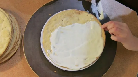Confectioner prepares Layer Cake puts on each layer of cream and sprinkle with Stock Footage 69728550