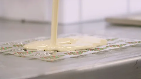 Confectioner preparing chocolates molds Stock Footage 98859253