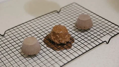 The confectioner preparing dessert with melted chocolate and chopped peanuts Stock Footage 134681178