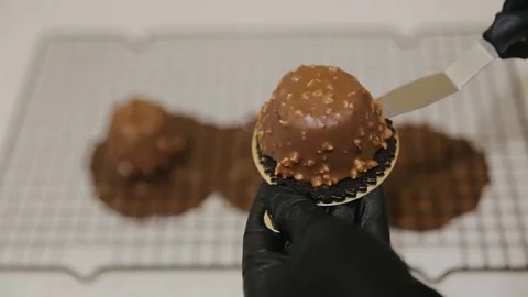 The confectioner preparing dessert with melted chocolate and chopped peanuts Stock Footage 134681207