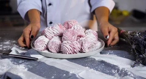 Confectioner preparing sweets at home kitchen Stock Photos