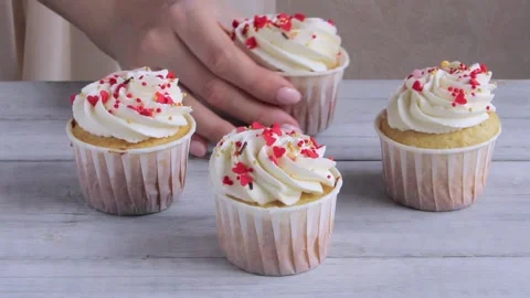 Confectioner putting cupcakes on the table. Close up Stock Footage 150463714