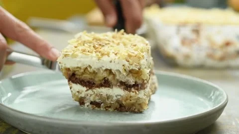 The confectioner serves piece of apple biscuit cake on the plate. Stock Footage 234892404