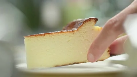 Confectioner serves a piece Basque cheesecake. Video stock 151688952