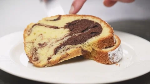 Confectioner serves a piece of marble cake on a plate. Stock Footage 152529375