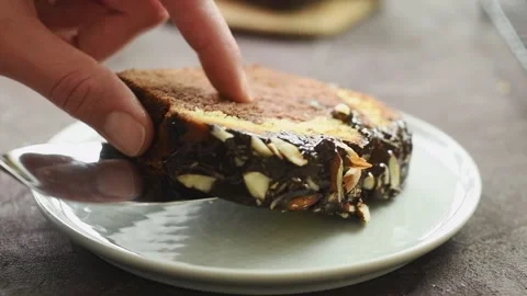 The confectioner serves piece of three layers chocolate cake. Stock Footage 194921104