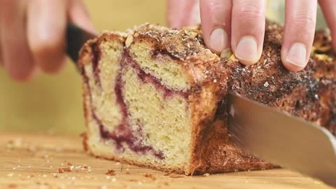 Confectioner slicing freshly baked raspberry babka. Stock Footage 166342667