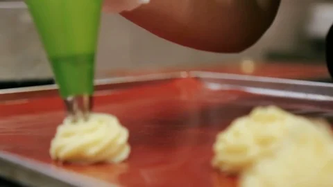 Confectioner squeezes form eclairs Stock Footage 69944035