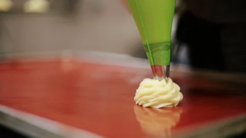 Confectioner squeezes form eclairs Stock Footage 69944156