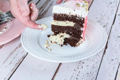 Confectioner taking a piece of stuffing from the cake. Chocolate cake with ma Stock Photos