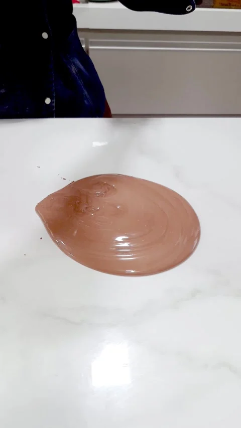 A confectioner tempering chocolate on a marble countertop vertical. Stock Footage 328052064