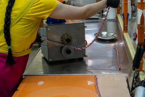 Confectioner Using Automatic Candy Sizer Machine to Shape Small Sweets Fotos Stock