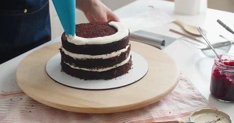 Confectioner at work. Cream cake decorating and filling. The confectioner fills Stock Footage 169959878