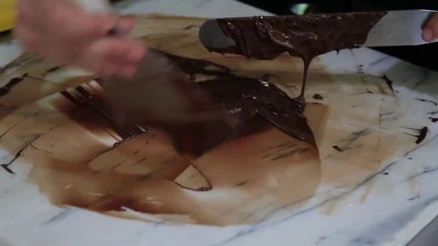 Confectioner working with liquid chocolate Stock Footage 72444711