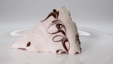 Confectionery concept. A piece of cherry cake covered with white cream Stock Footage 170374685