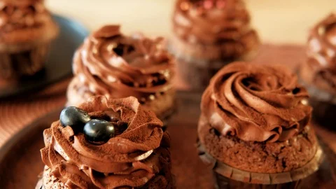 Confectionery decorator put berries top cupcakes Stock Footage 112219630
