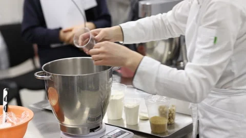 Confectionery master class. The pastry chef teaches girls how to make dessert. Stock Footage 146478607