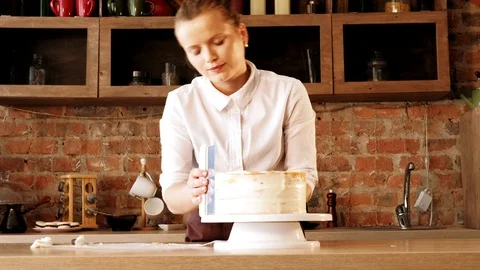 Confectionery master classy chef cake scraping off Stock Footage 112220741