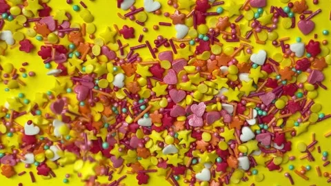 Confectionery sprinkles pouring down to create a full frame background Stock Footage 338186383