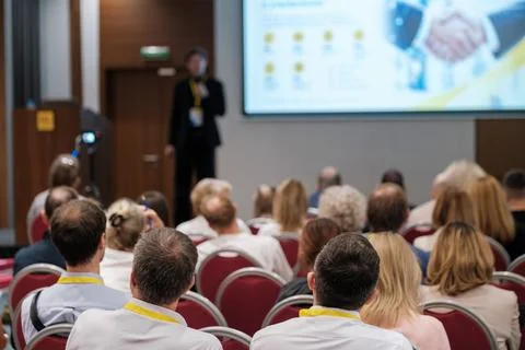 Conference presentation with a handshake image on screen Stock Photos
