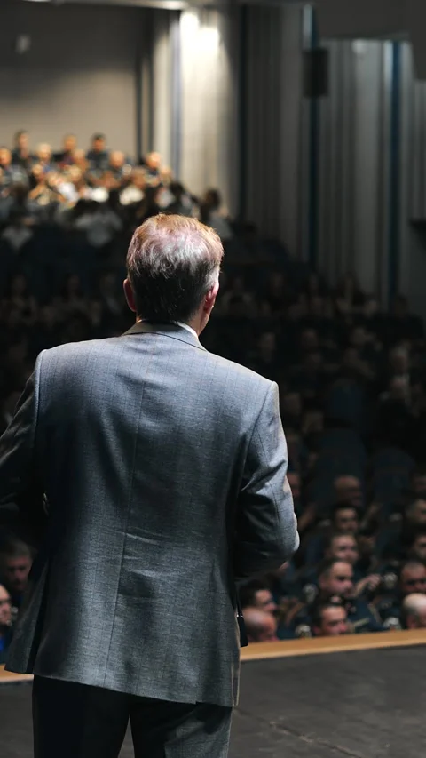 Conference Speaker Addressing Large Audience From Stage Stock Footage 345560948