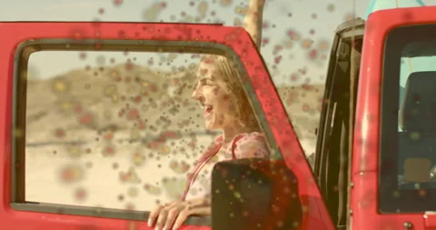 Confetti drifting past open Jeep window sparking woman catching particles in Stock Footage 314845240