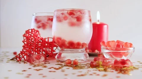 Confetti falling down, slow motion. Two glasses with alcohol decorated. Stock Footage 71693487