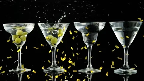 Confetti falling, olives dropping into martini glasses, causing splash and 库存影片 321889454