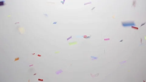 Confetti falling over white background Stock Footage