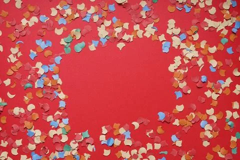 Confetti frame on red paper background confetti frame or border on red pap... Stock Photos