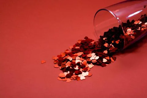 Confetti on a red background. Stock Photos