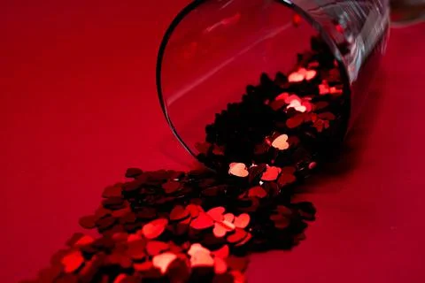 Confetti on a red background. Stock Photos