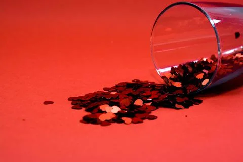 Confetti on a red background. Stock Photos