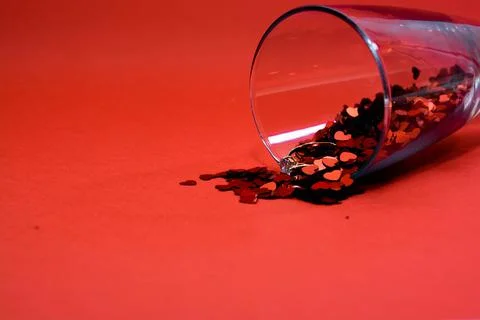 Confetti on a red background. Stock Photos