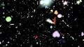 Confetti shapes falling away from camera slow motion DOF loop on black HD Footage