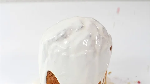 Confetti is sprinkles on top of Easter Cake with white glaze, close-up. Stock Footage 126580622