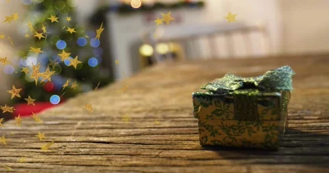 Confetti starting edge drifting over table toward gift box beside lit tree, Stock Footage 320507004