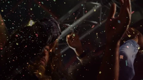 Confetti starting to fall, crowd members raising hands, clapping, celebrating Stock Footage 332545070