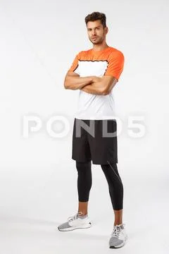 Confidence, sport and fitness concept. Vertical shot good-looking bearded Stock Photos