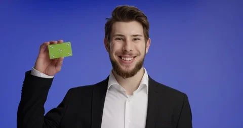 Confident and good looking man raising buisness card Stock-Footage 99459570
