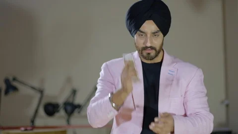 Confident and sharp smart black turbaned man on a smart phone mobile camera make Stock Footage 102419654