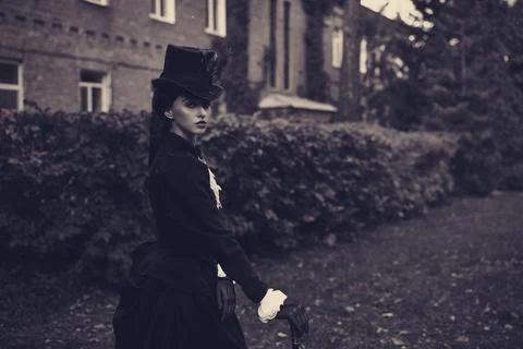 A confident and sophisticated lady in a strict black suit of the 19th century Fotos de archivo