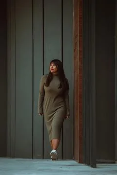 A confident and stylish plus-size woman walking by Stock Photos